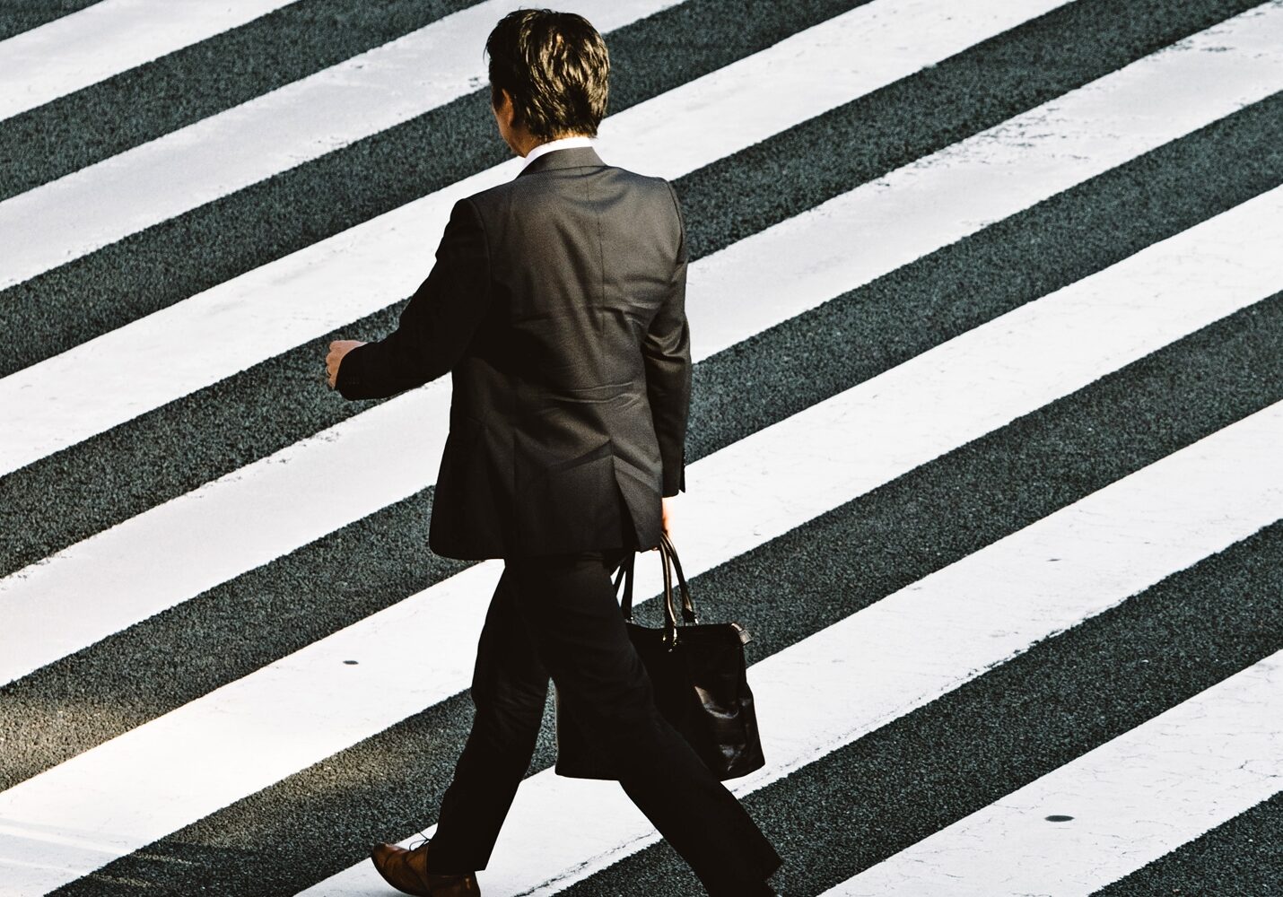 business man crossing street